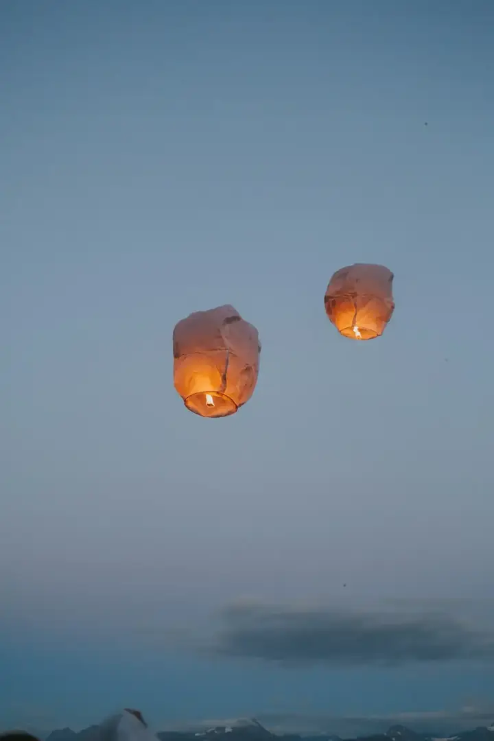 Paper lanterns glowing warmly at dusk